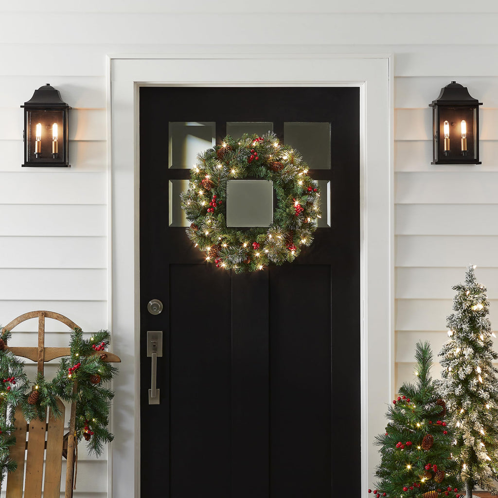 National Tree Company Pre-Lit Artificial Christmas Wreath, Green, Crestwood Spruce, White Lights, Decorated with Pine Cones, Berry Clusters, Christmas Collection, 24 Inches